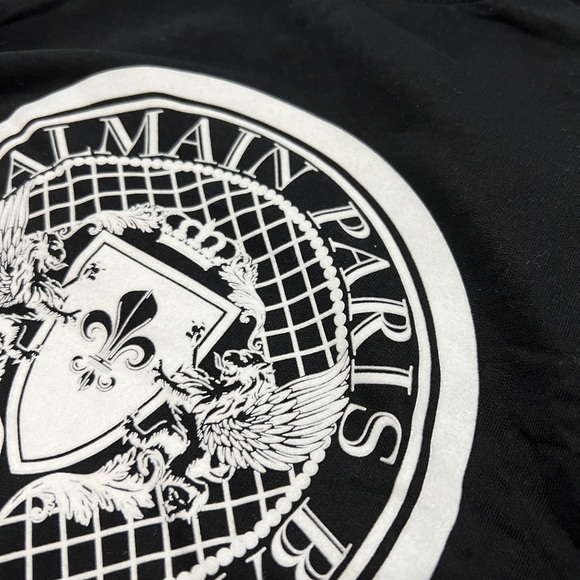Balmain black crew neck sweater with white velvet medallion. - Picture 2 of 7